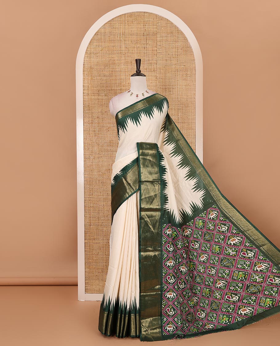 Cream-green plain dola-tussar saree, contrast temple zari border, patola animal motifs enclosed jaal printed pallu & patola printed blouse