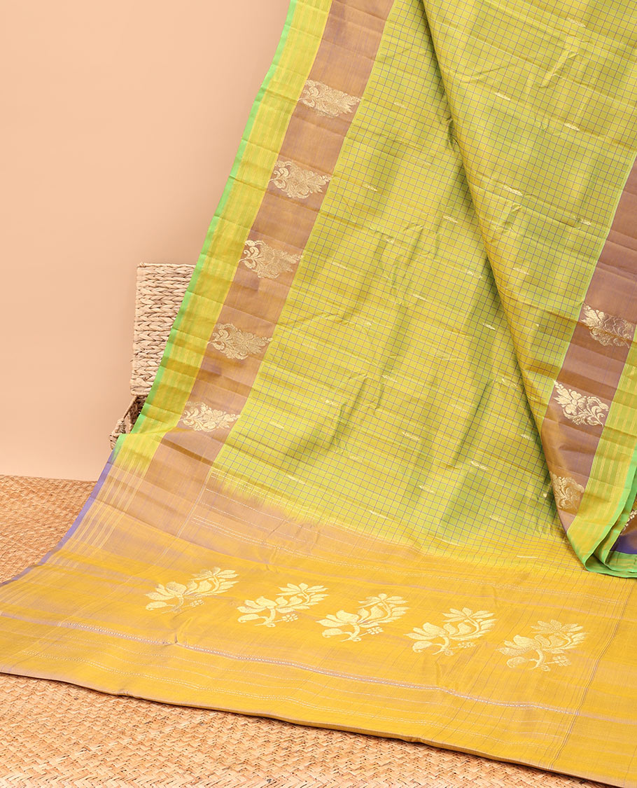 Green checked kancheepuram silk saree with contrast floral zari design & intricate zari design pallu