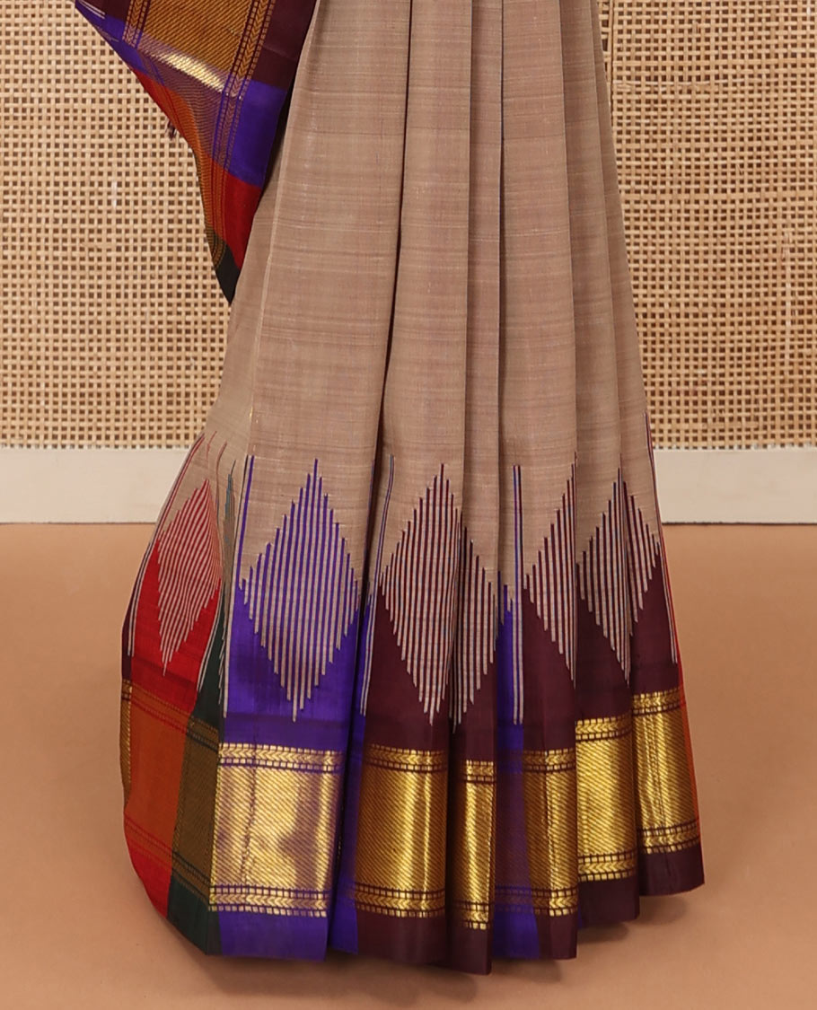 Brown zari buttas Kanchipuram silk saree, contrast multi-colored one-sided thazampoo rekku zari border, and multi-colored zari striped pallu