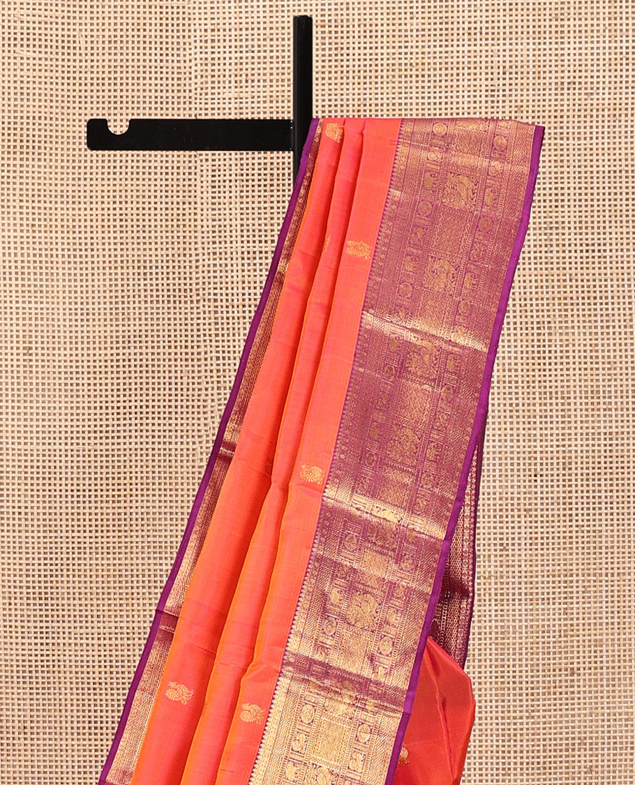 Orange Kanchipuram Silk Saree, Gracefully Embellished with Mayil Buttas, Complemented by a Contrast Border of Thilakam Mokku, Rudaraksham, Mayil Kann, Chakram, Yaanai, Mayil, and Jaal Designs, Pallu of Zari Designs, and Paired with a Contrast Blouse