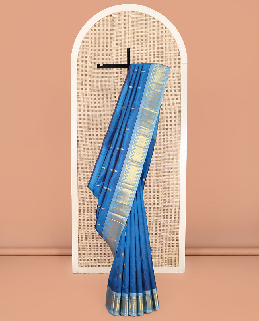 Blue Kanchipuram Silk Saree, Beautified with Zari Buttas on Its Body, Complemented by a Contrast One-Sided Border of Panner Sombu, Banaras, Muthu, and Jaal Designs, Pallu Depicts Zari Designs, and Comes Without a Blouse
