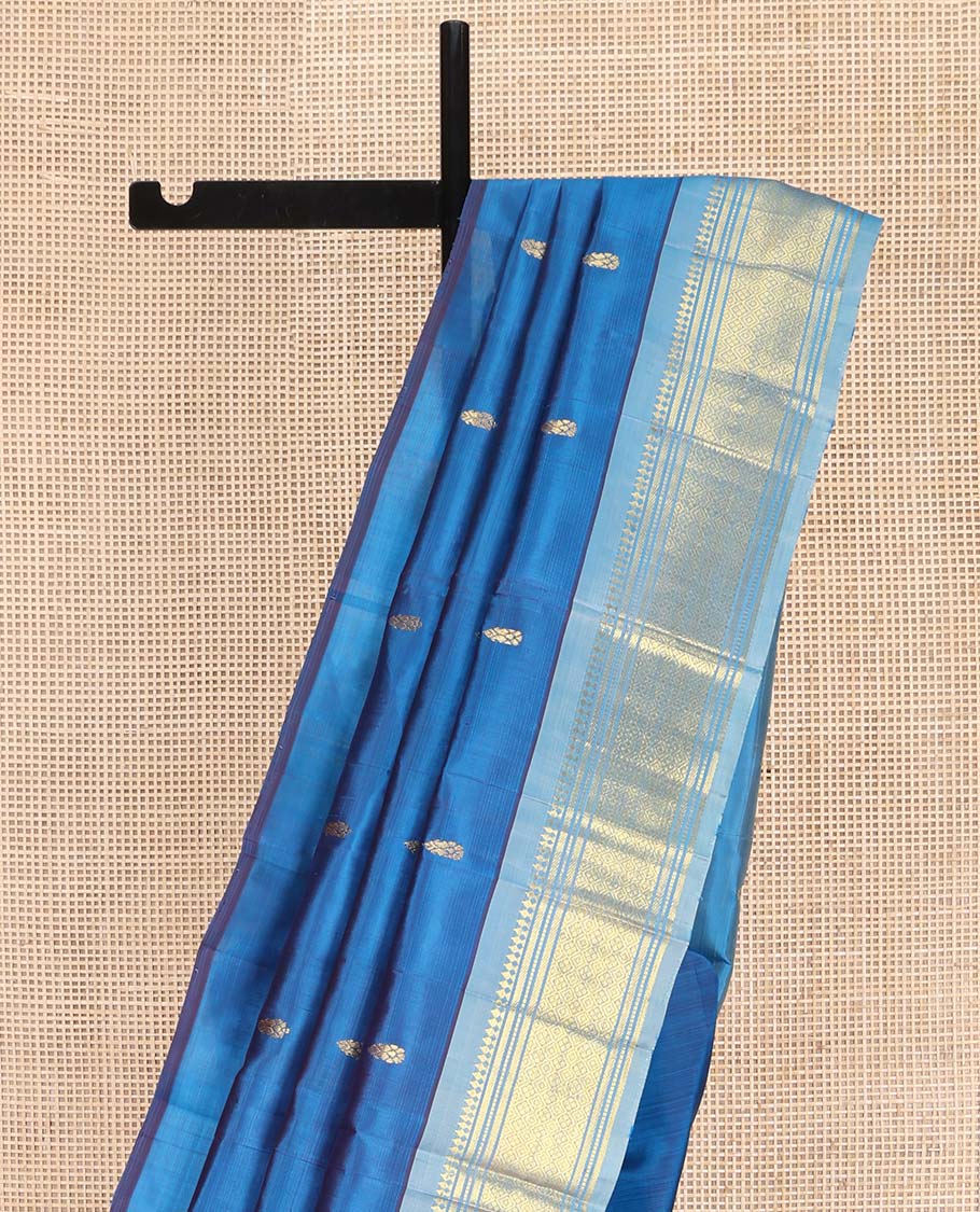 Blue Kanchipuram Silk Saree, Beautified with Zari Buttas on Its Body, Complemented by a Contrast One-Sided Border of Panner Sombu, Banaras, Muthu, and Jaal Designs, Pallu Depicts Zari Designs, and Comes Without a Blouse