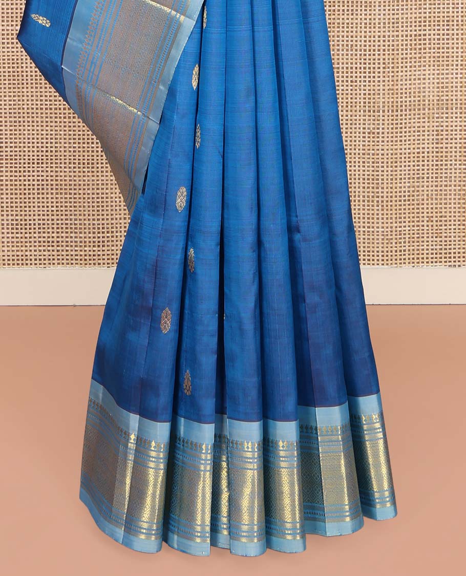 Blue Kanchipuram Silk Saree, Beautified with Zari Buttas on Its Body, Complemented by a Contrast One-Sided Border of Panner Sombu, Banaras, Muthu, and Jaal Designs, Pallu Depicts Zari Designs, and Comes Without a Blouse