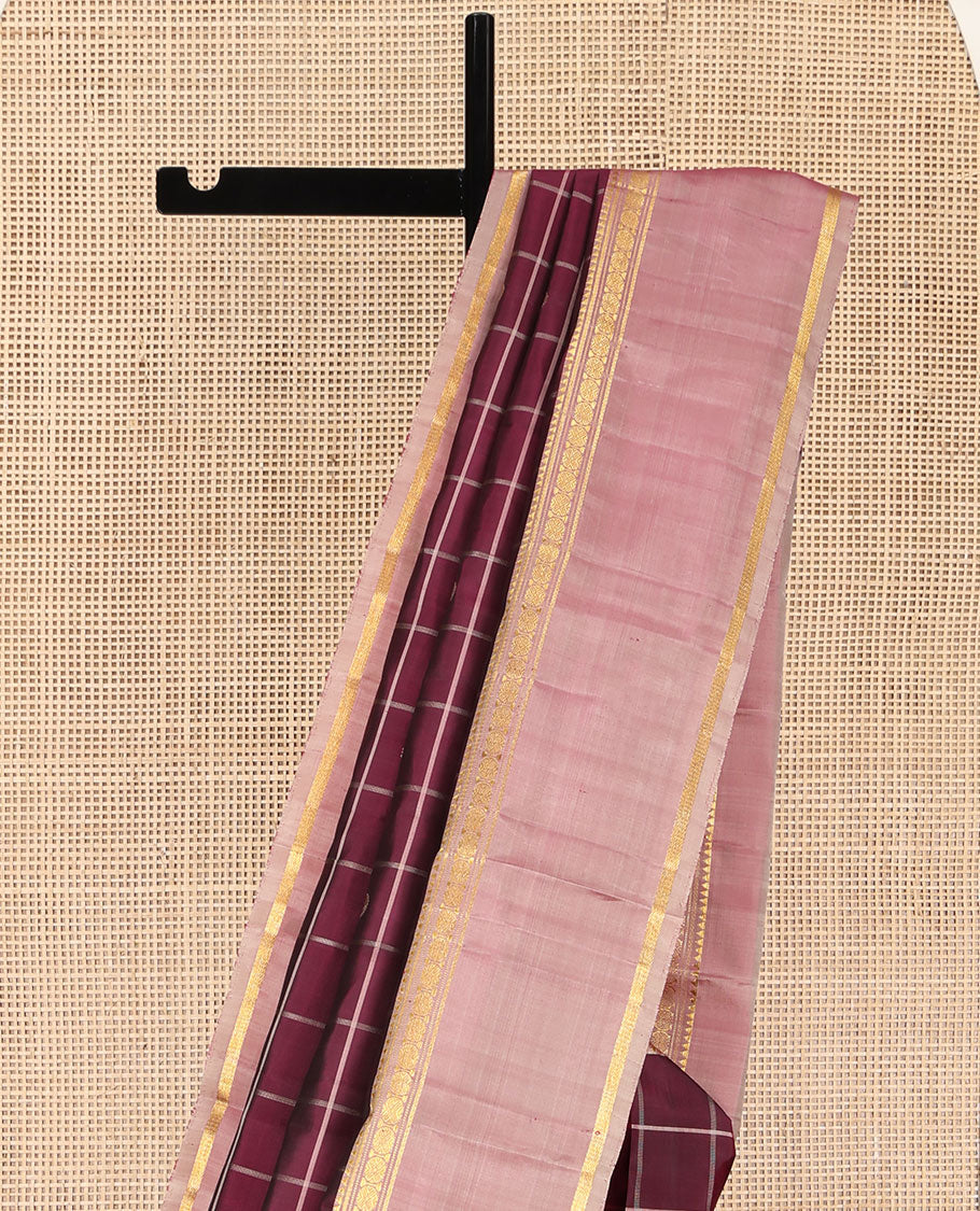 Maroon Kanchipuram Silk Saree, Richly Detailed with Chakram Buttas Enclosed Checks, Complemented by a Contrast Rettai Pettu Border of Rekku, Banaras, Muthu, and Poun Designs, Pallu Steeped with Chakram Motifs, and Paired with a Contrast Blouse