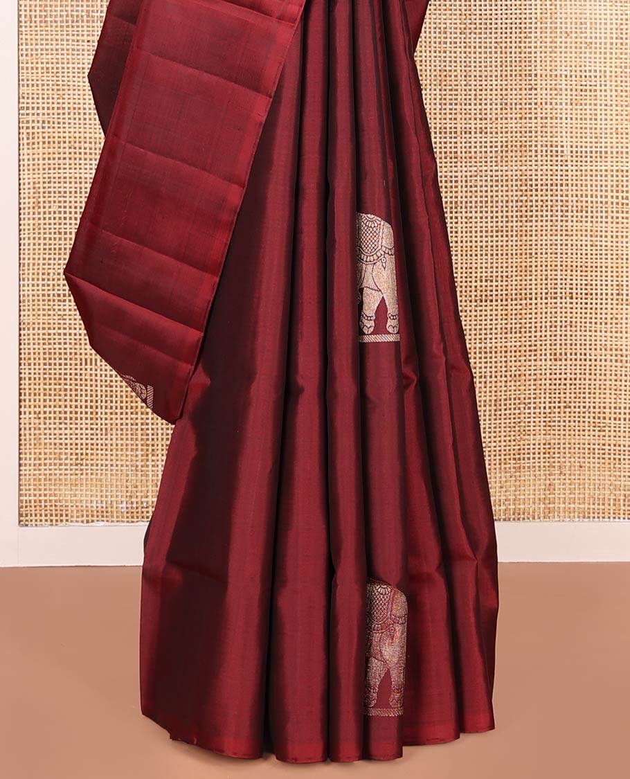 Borderless Maroon Mayuri Soft Silk Saree, Beautifully Bedecked with Vrishabha-Kunjara Buttas, Highlighted by Pallu of Vrishabha-Kunjara and Geometric Designs, and Paired with Matching Blouse
