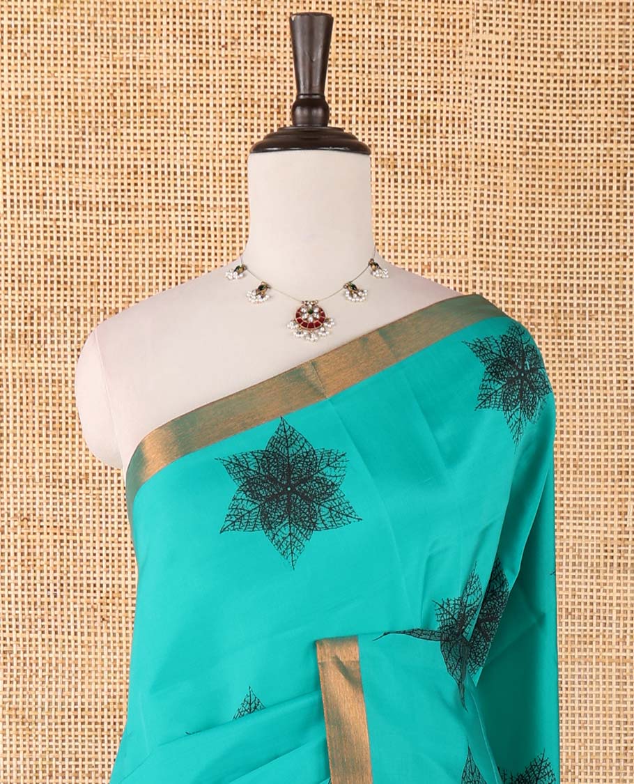 Blue six-petal-like leaf motifs printed micro-silk saree, copper zari border, contrast intricate pallu & plain blouse
