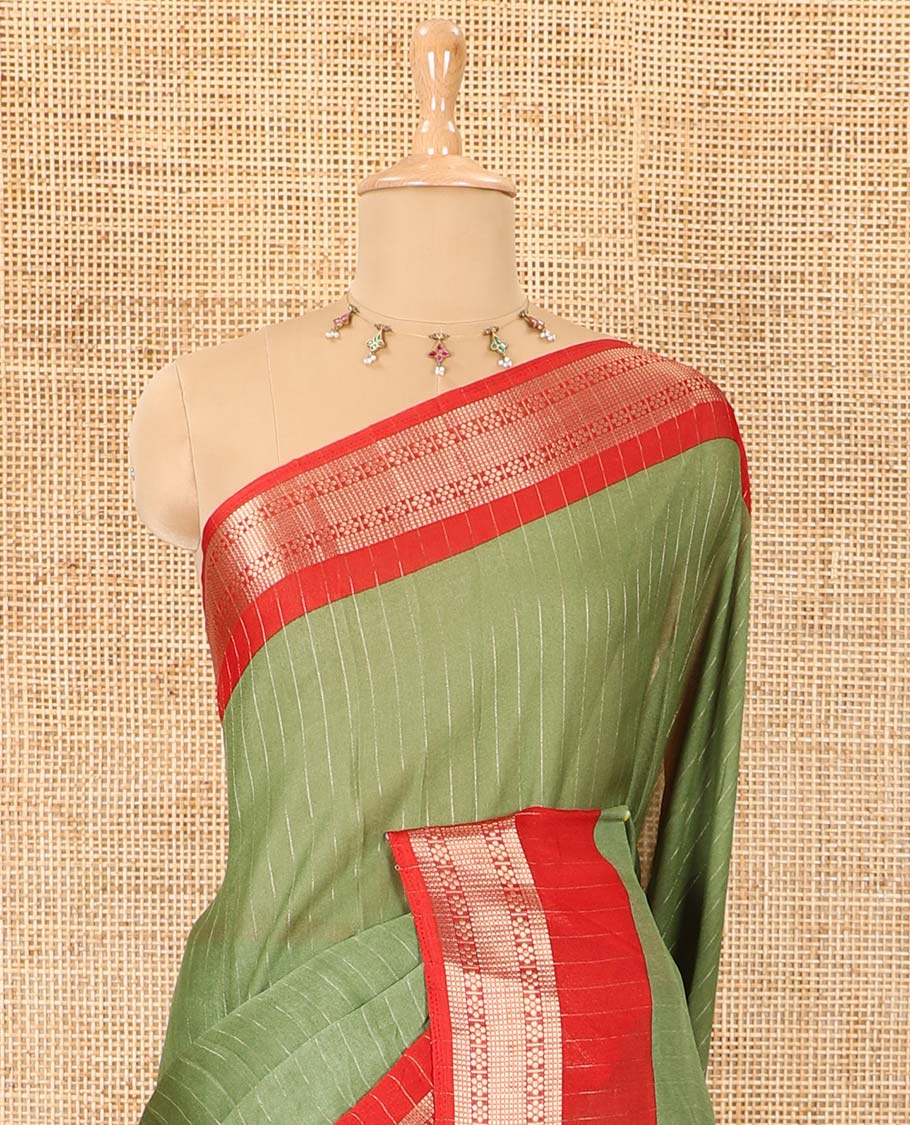 Green vertically striped moss chiffon saree with contrast traditional zari design borders, striped pallu, and a contrast blouse