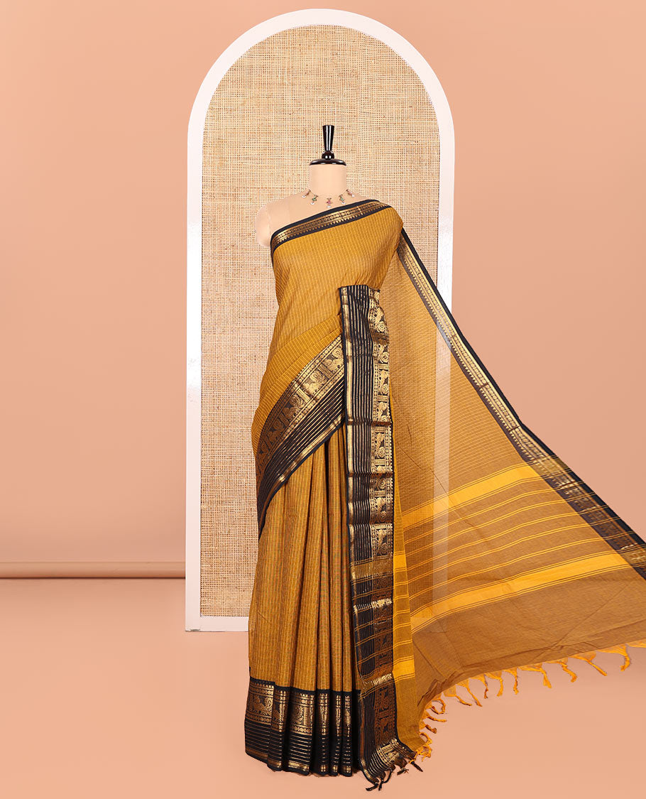 Gold Chettinad Cotton Saree Subtly Sparkled with Stripes All Over Its Body, Complemented by Contrast Traditional Zari Border of Peacock Designs, Subtly Striped Pallu, and Paired with a Matching Blouse