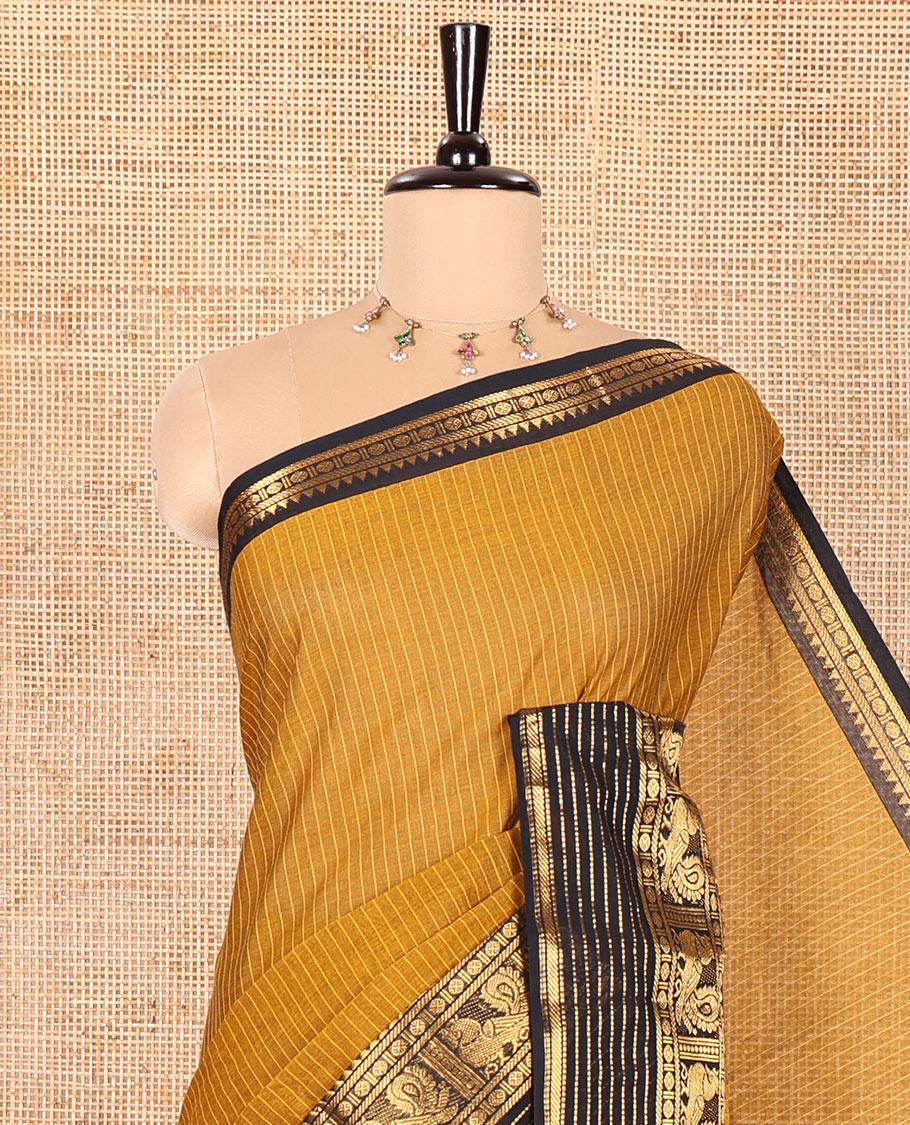 Gold Chettinad Cotton Saree Subtly Sparkled with Stripes All Over Its Body, Complemented by Contrast Traditional Zari Border of Peacock Designs, Subtly Striped Pallu, and Paired with a Matching Blouse