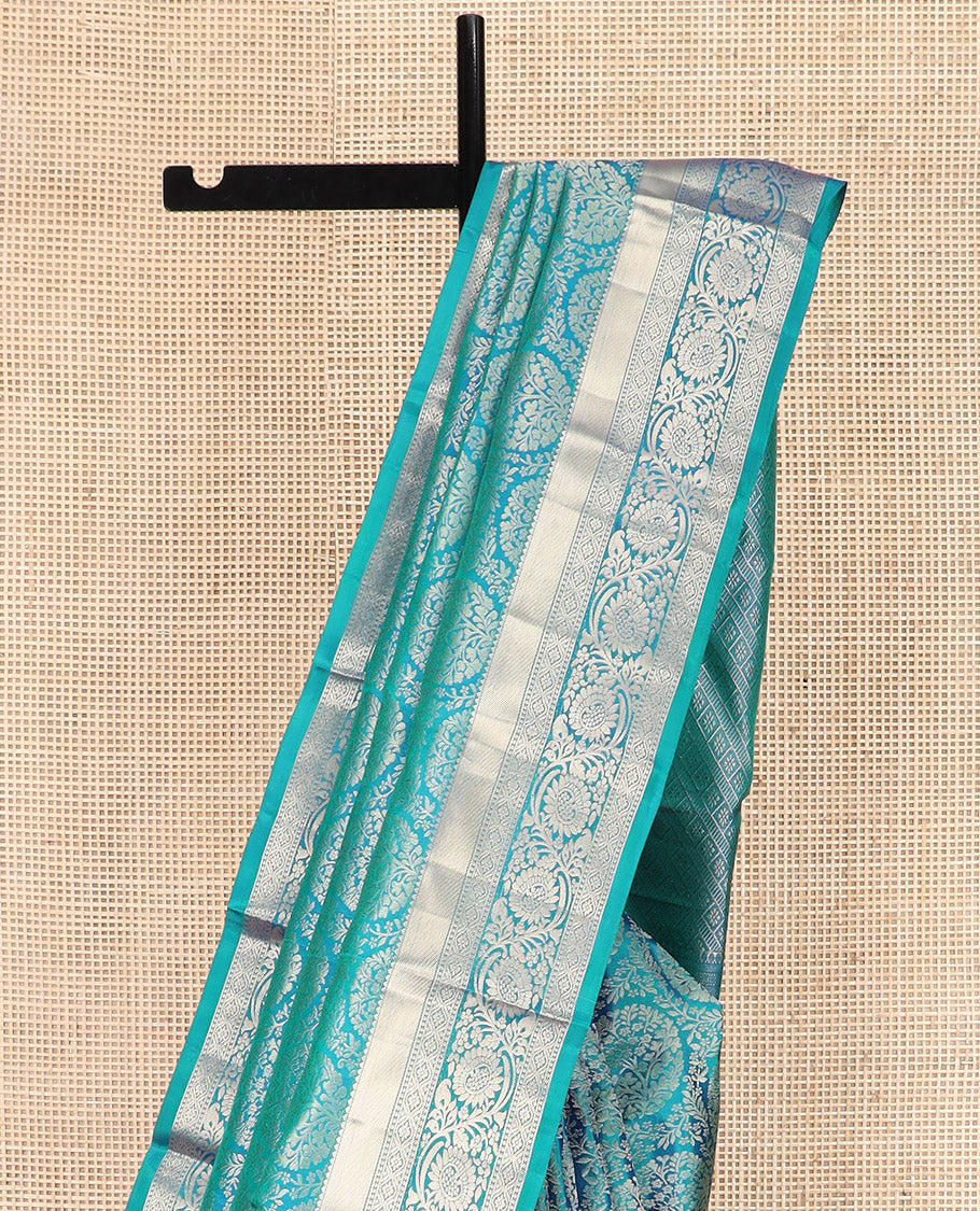 Peacock Blue Kanchipuram Silk Saree Opulently Embellished with Jacquard Design, Highlighted with Zari Border of Rekku, Ogee, and Kodi Visiry Designs, Elegantly Detailed Pallu of Geometric Designs, and Paired with a Matching Blouse