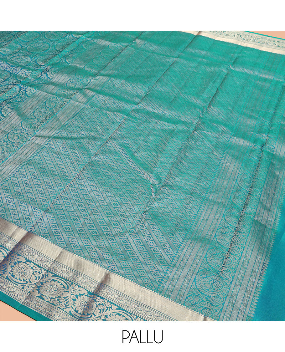 Peacock Blue Kanchipuram Silk Saree Opulently Embellished with Jacquard Design, Highlighted with Zari Border of Rekku, Ogee, and Kodi Visiry Designs, Elegantly Detailed Pallu of Geometric Designs, and Paired with a Matching Blouse