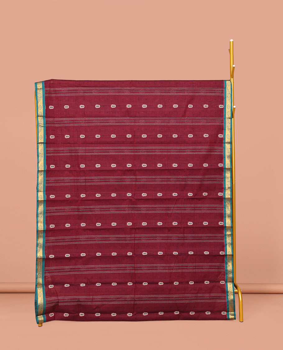 Maroon Kanchi Cotton Saree, Adorned with Buttas and Stripes on Its Body, Complemented by Contrast Zari Border, a Pallu of Jaal Designs, and Paired with a Matching Blouse