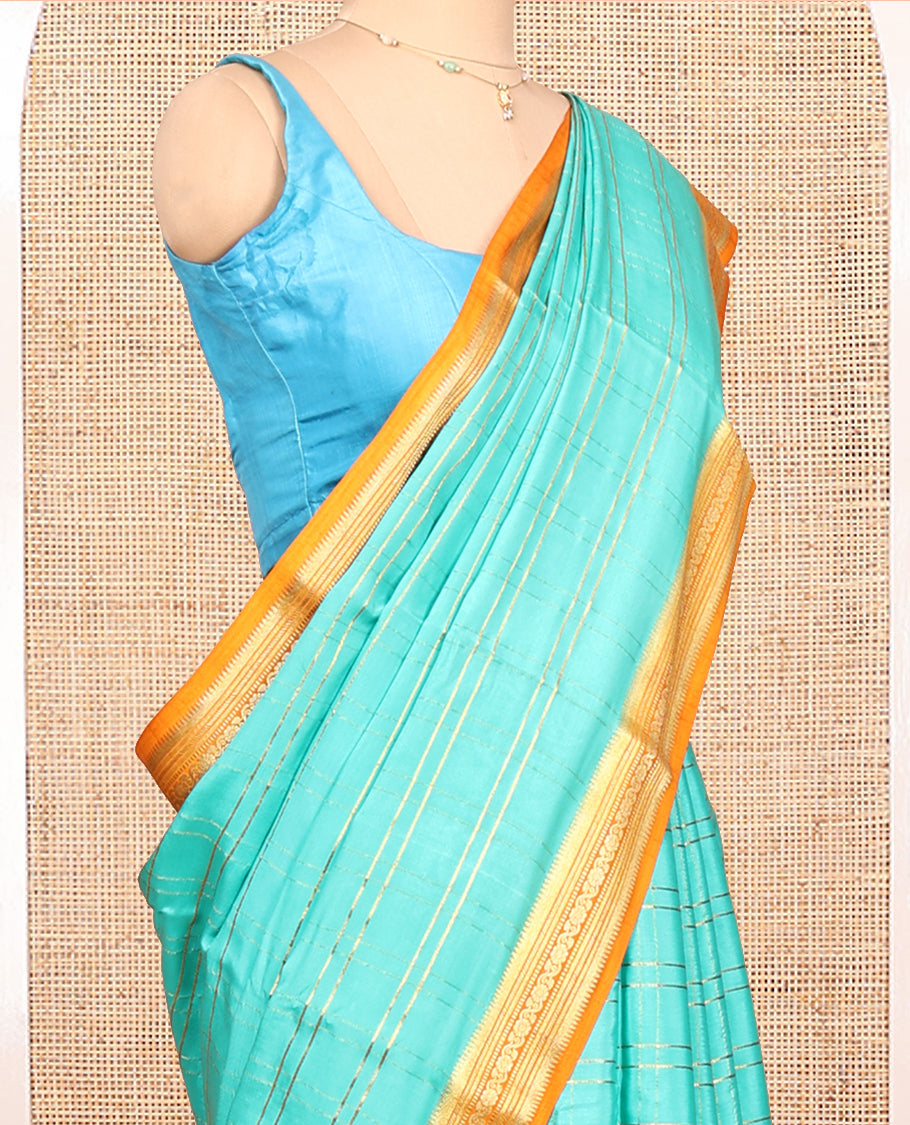 Blue Mysore Silk Saree, Gleamed up with Zari Checked Design on its Body, Complemented by Captivating Contrast Border of Traditional Zari Designs, Pallu of Tropical Flora and Flamingo Bird Designs, and Paired with a Contrast Blouse