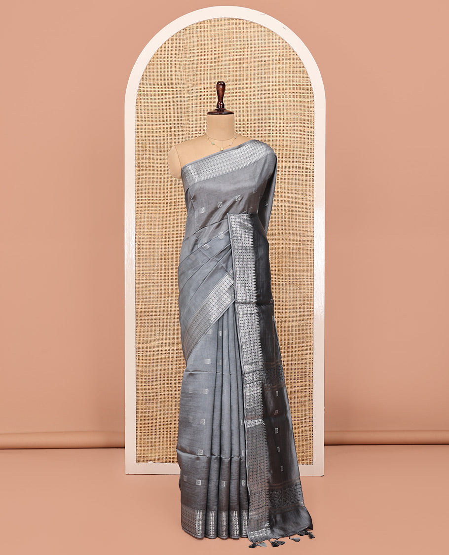 Grey Banana Pith Saree, Subtly Sparkled with Buttas All Over Its Body, Highlighted by Self-Border of Temple and Rudraksham Motifs, Pallu Steeped with Stripes and Buttas, and Paired with a Matching Blouse