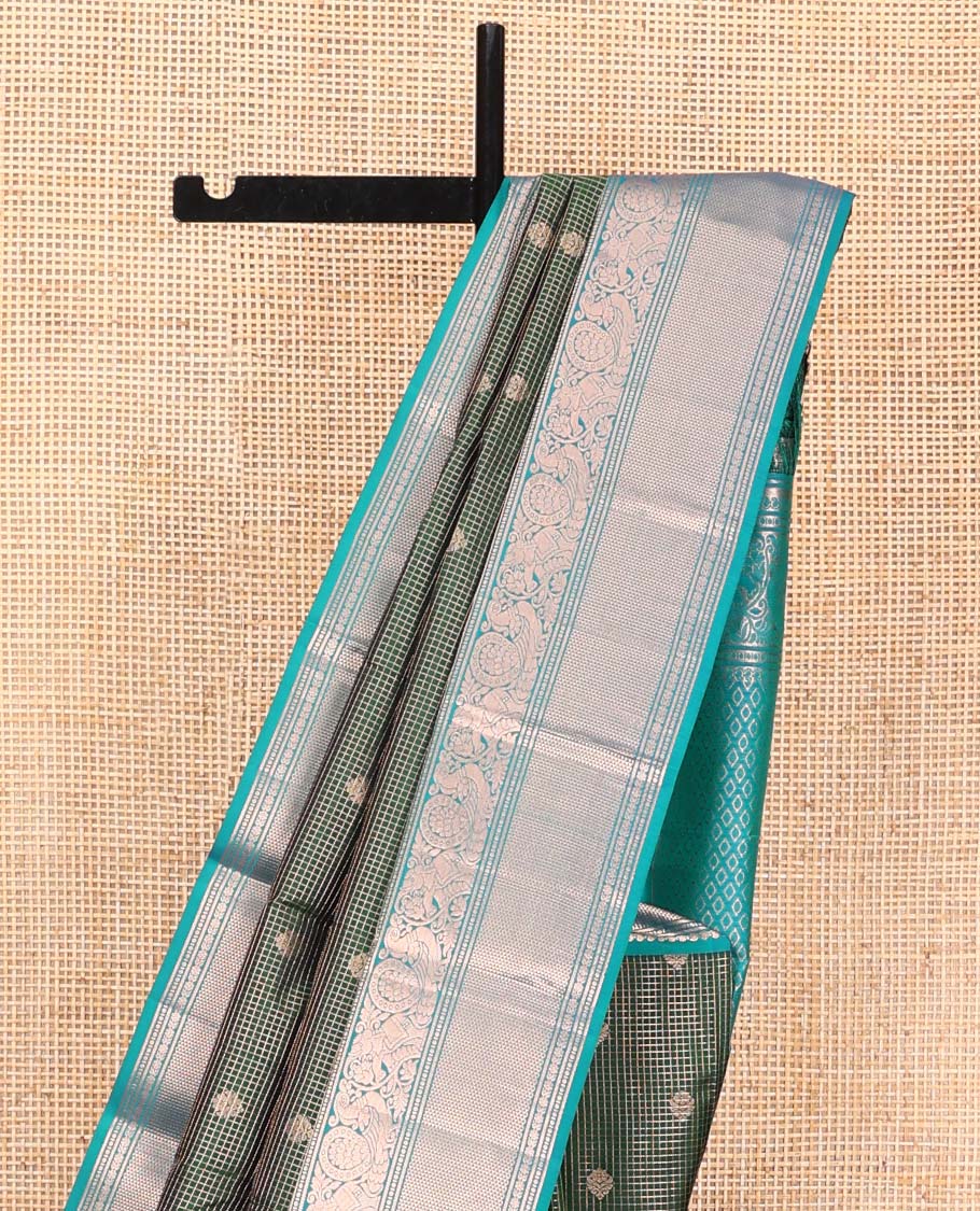 Green Vasundhara Silk Saree, Steeped in Richness of Zari Buttas and Checked Design on Its Body, Complemented by a Contrast Border of Manga, Floral, Mayil, Yaanai, and Ara Maadam Designs, Opulently Embellished Jaal Pallu, and Paired with a Contrast Blouse