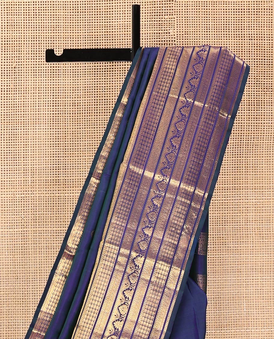 Blue Kanchipuram Silk Saree, Embellished with Mayil and Chakram Buttas All Over Its Body, Highlighted by a Zari Border of Traditional Designs, Pallu Steeped with Traditional Designs, and Paried with a Matching Blouse