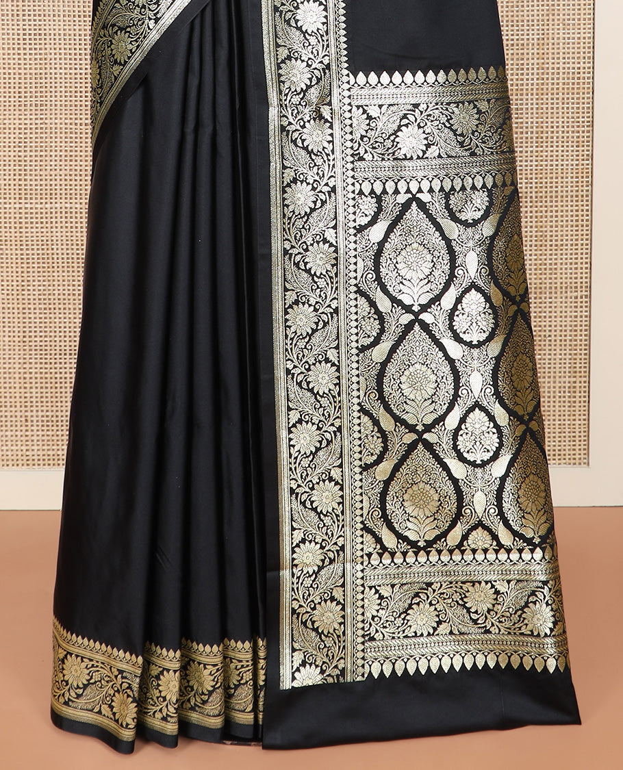 Inky Black Semi-Banaras Satin Saree, Subtly Sparkled Border of Floral Creeper Designs, Pallu Beautified with Thilak Motifs in Zari, and Paired with a Matching Blouse