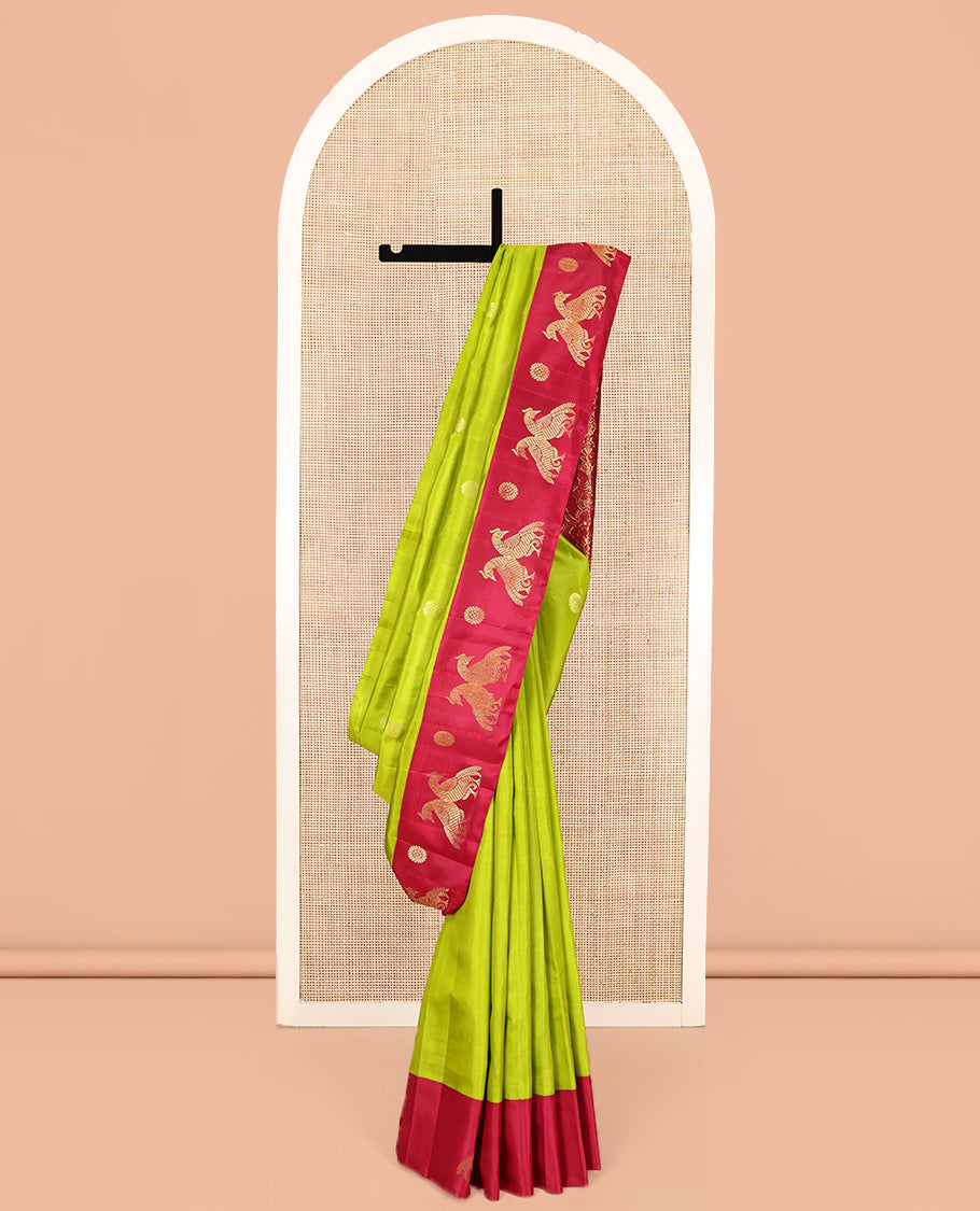 Green Kanchipuram Silk Saree, Styled with Chakram Buttas, Complemented by a Contrast One-Sided Korvai Border of Mayil and Chakram Designs, Pallu Steeped with Mayil Designs, and No Blouse