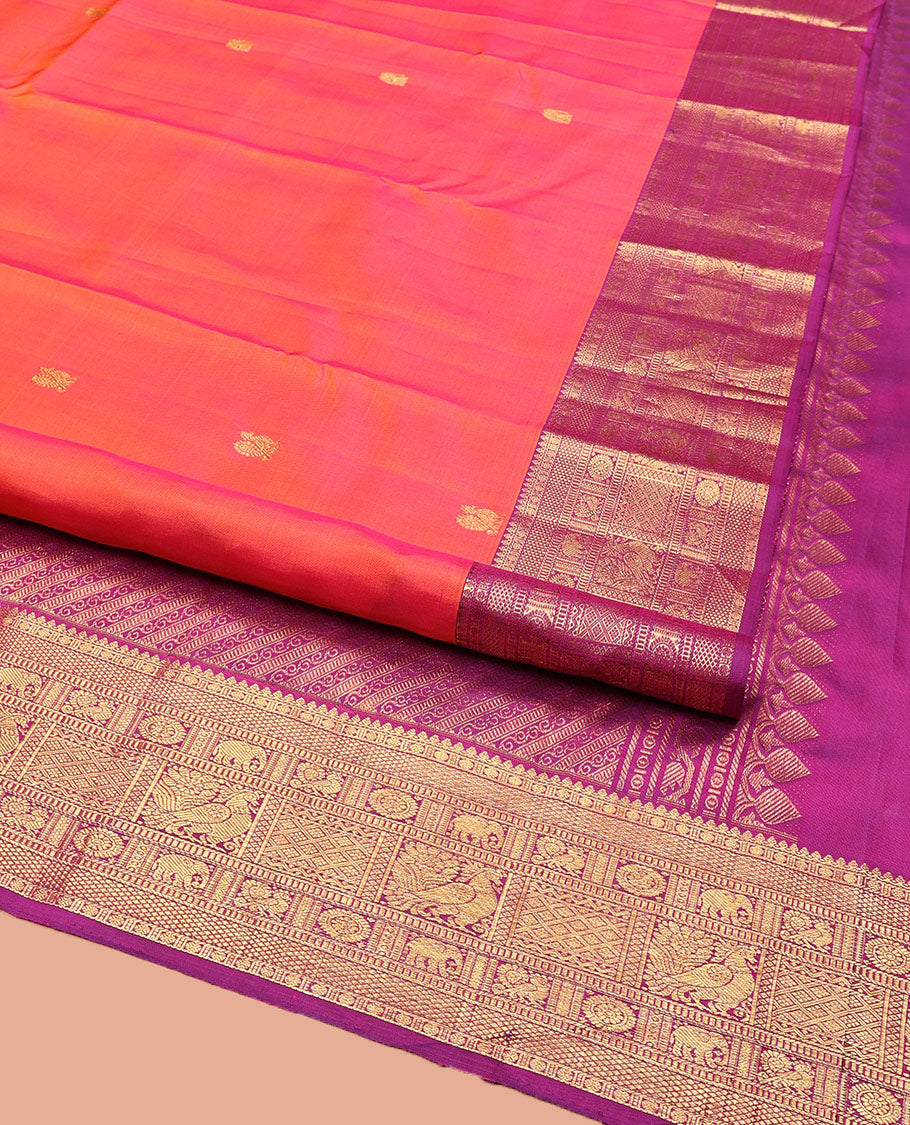 Orange Kanchipuram Silk Saree, Gracefully Embellished with Mayil Buttas, Complemented by a Contrast Border of Thilakam Mokku, Rudaraksham, Mayil Kann, Chakram, Yaanai, Mayil, and Jaal Designs, Pallu of Zari Designs, and Paired with a Contrast Blouse