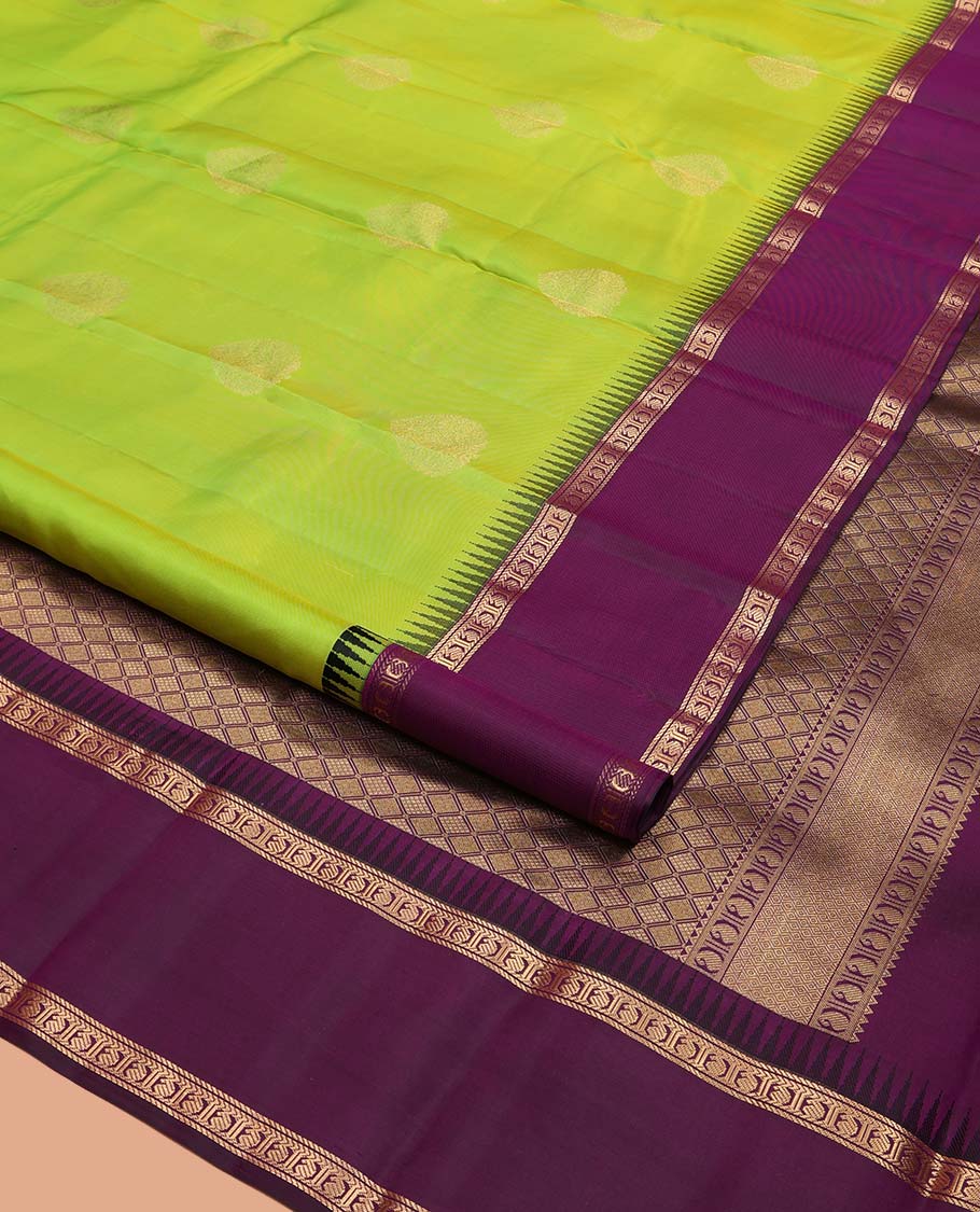 Green Vasundhara Silk Saree, Delicately Woven with Zari Buttas All Over Its Body, Complemented by a Contrast Rettai Pettu Temple Border of Banaras, and Manga Designs, Grand Jaal Pallu, and Paired with a Contrast Blouse