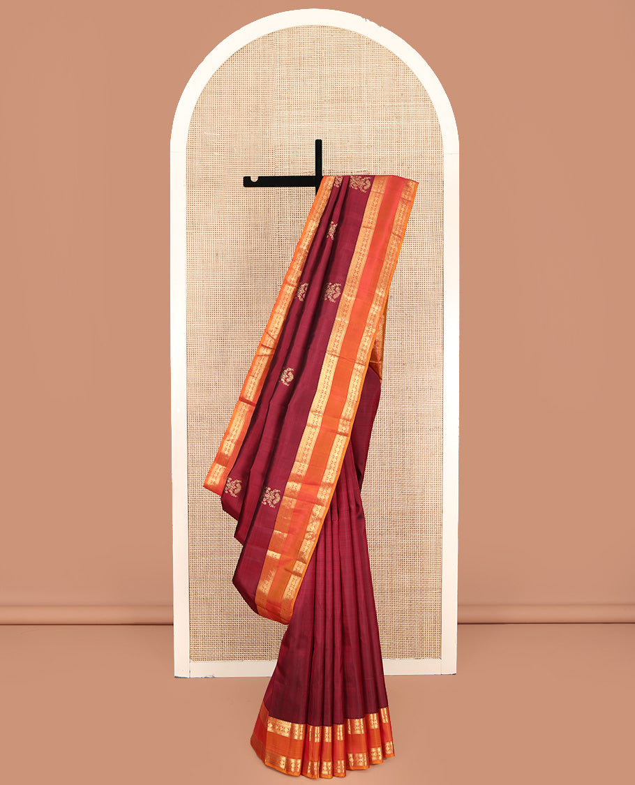 Red Kanchipuram Silk Saree, Enriched with Zari Buttas All Over Its Body, Complemented by Contrast Rettai Pettu Border of Manga Mokku, Muthu, Banaras, and Poun Designs, Grand Pallu, and Paired with a Contrast Blouse