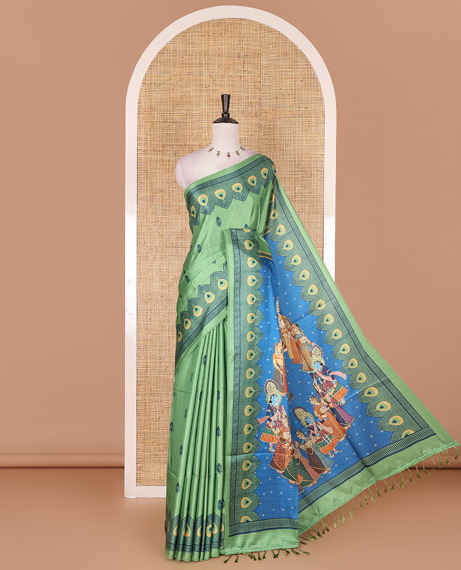 Parrot green peacock feathers motifs printed katan silk saree, peacock feathers printed border, contrast Radha Krishna stories printed pallu, and contrast printed blouse