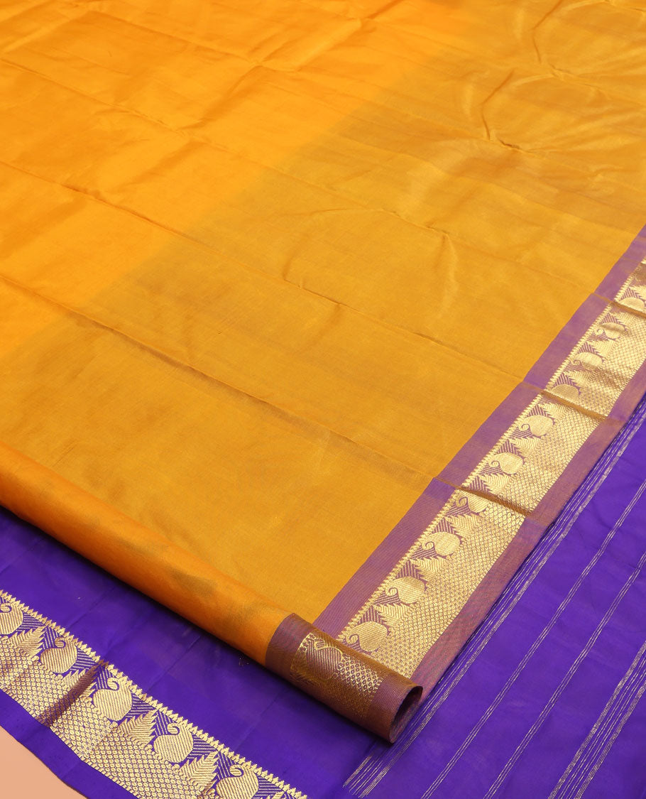 Yellow Kanchipuram Silk Saree, Subtly Sparkled with Zari Buttas, a Contrast Border of Thazampoo Rekku, Muthu, Manga, and Mayil Kann Designs, Zari Pallu, and a Contrast Blouse