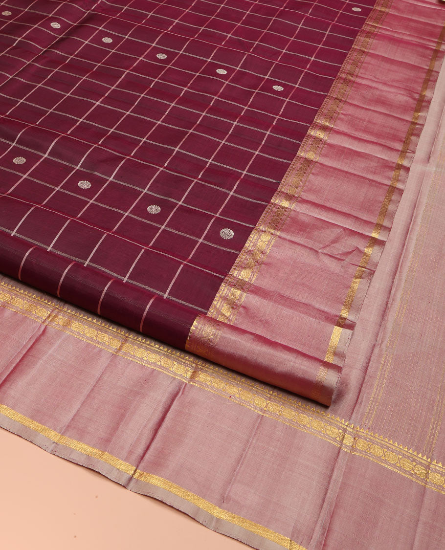 Maroon Kanchipuram Silk Saree, Richly Detailed with Chakram Buttas Enclosed Checks, Complemented by a Contrast Rettai Pettu Border of Rekku, Banaras, Muthu, and Poun Designs, Pallu Steeped with Chakram Motifs, and Paired with a Contrast Blouse
