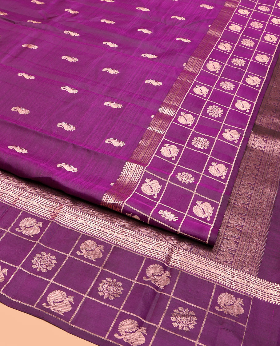 Purple Vasundhara Silk Saree, Artfully Detailed with Zari Buttas, Highlighted by a Zari Border of Rekku, Muthu, Jada Nagam, and Butta Enclosed Checks, Jaal Pallu, and a Matching Blouse