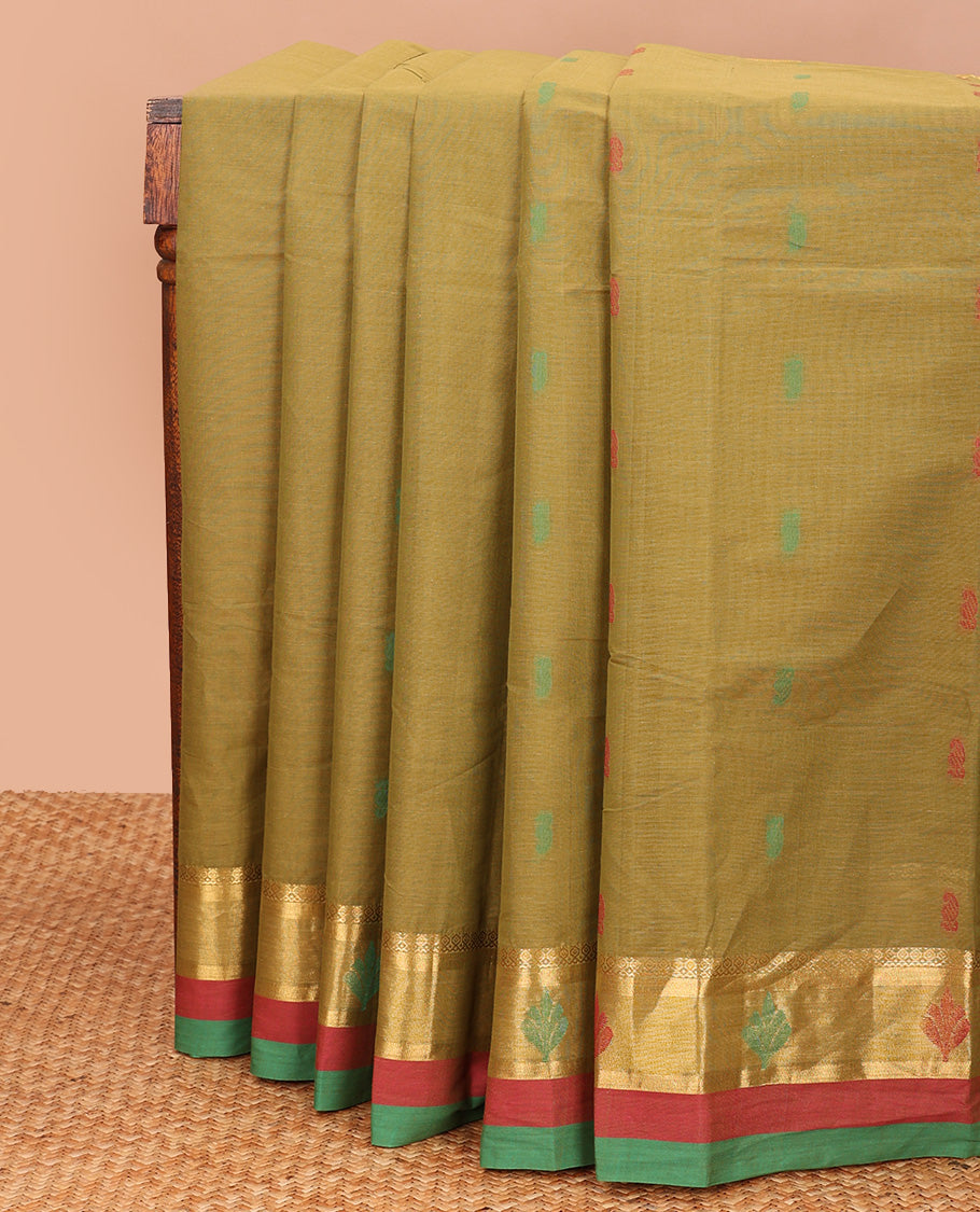 Green buttas kanchi cotton saree, contrast thread and zari border, and pallu of paisley and leaf vine