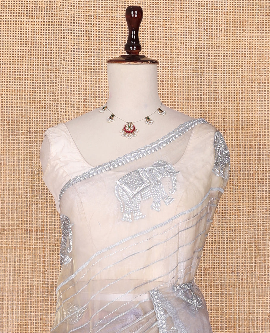 Cream stone embroidered elephant motifs designer saree, scallop crystal stone border & pallu of elephant embroidery