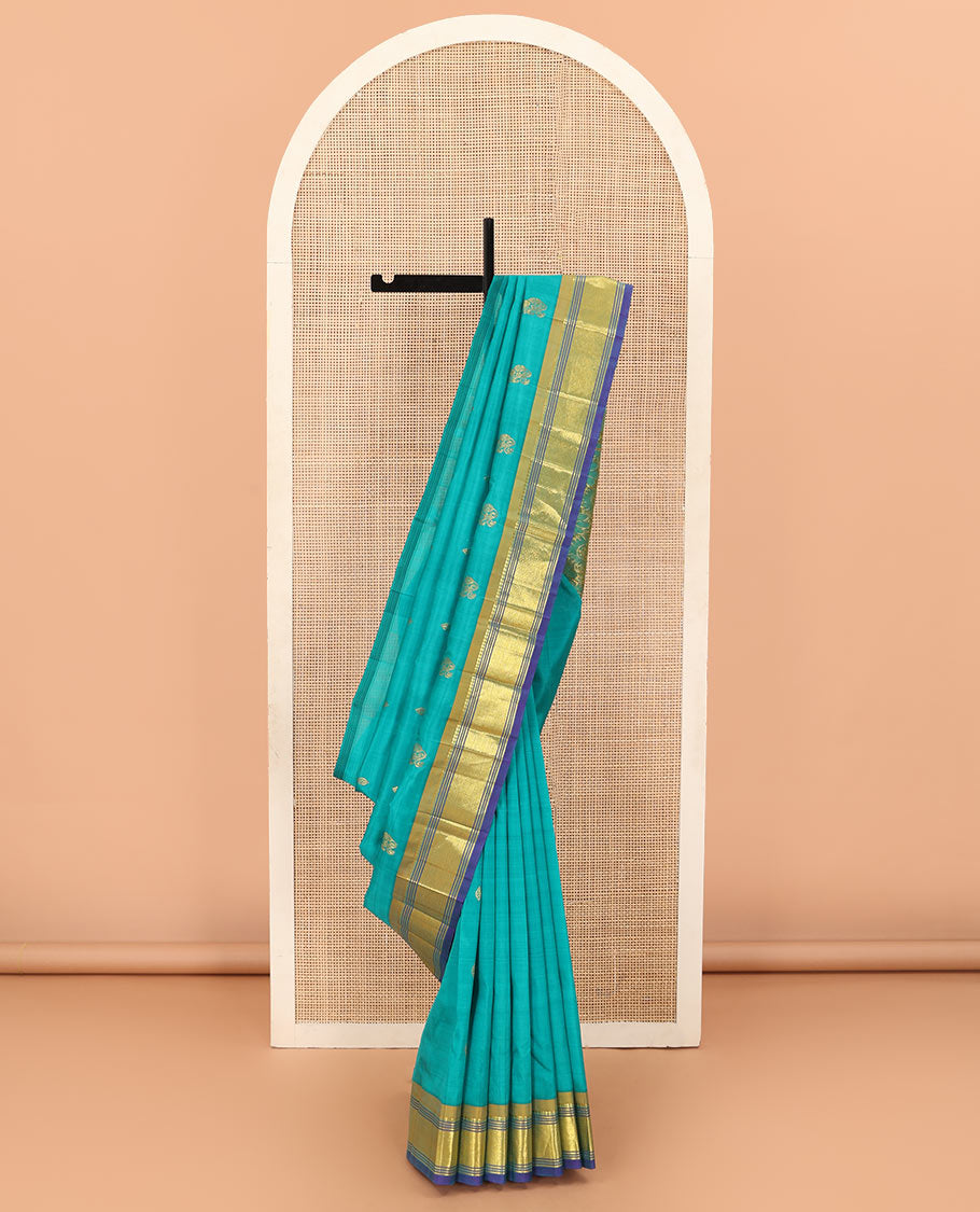 Blue zari buttas Kanchipuram silk saree, contrast border of paneer sombu, banaras, muthu, and mayil kann designs, and floral design pallu