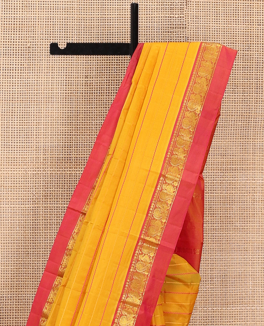 Yellow Kanchipuram Silk Saree Bedecked with Resham Threads Neli Stripes, Elevated with Contrast Kal Erangina Border Featuring Manga, Muthu, and Mayil Designs, Sparsely Woven Pallu, and Paired with a Contrast Blouse