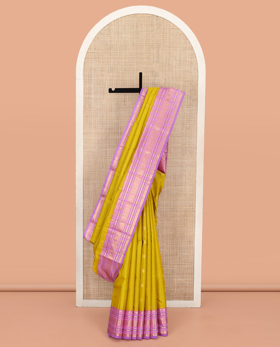 Green Vasundhara Silk Saree, Sparsely Threaded with Zari Buttas All Over Its Body, Complemented by a Contrast Border of Rekku, Muthu, Kathir, Poun, Mayil, and Mayil Kann Designs, Grandly Decked Up Pallu, and Paired with a Contrast Blouse