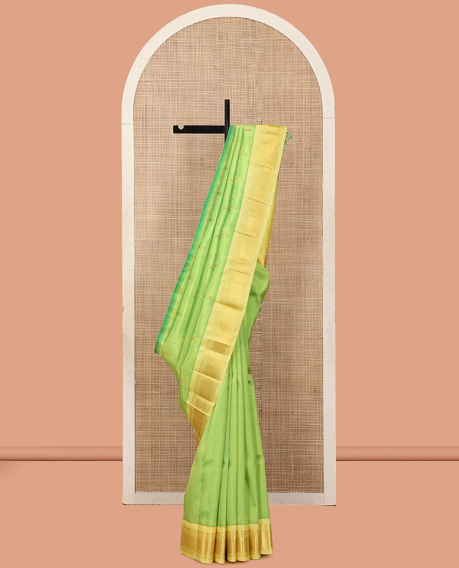 Green Kanchipuram Silk Saree, Woven with Zari Buttas, a Contrast One-Sided Border of Panner Sombu, Banaras, Muthu, and Jaal Designs, a Zari Design Pallu, and No Blouse