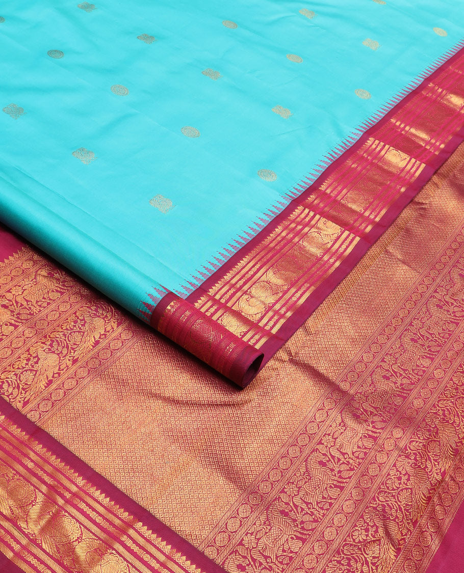 Blue mayil chakram buttas Kanchipuram silk saree, contrast thazampoo rekku border of thilakam mokku, banaras, rudraksham, and mayil designs, and intricate pallu
