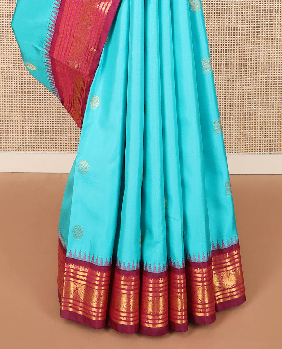 Blue mayil chakram buttas Kanchipuram silk saree, contrast thazampoo rekku border of thilakam mokku, banaras, rudraksham, and mayil designs, and intricate pallu