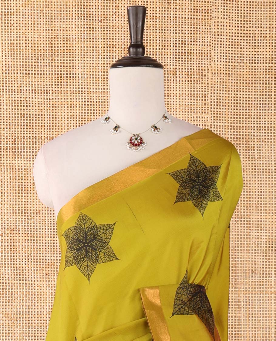 Mehendi green six-petal-like leaf motifs printed micro-silk saree, copper zari border, contrast intricate pallu & plain blouse