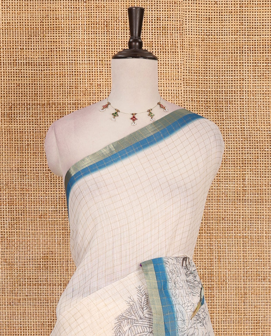 White with blue zari checks linen saree with contrast border and unique designs of pallu along with contrast plain blouse
