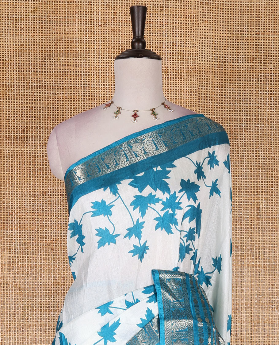 Blue leaf motifs printed dola silk saree, contrast traditional zari border of Rudraksham and peacock motifs, geometric printed pallu and contrast printed blouse