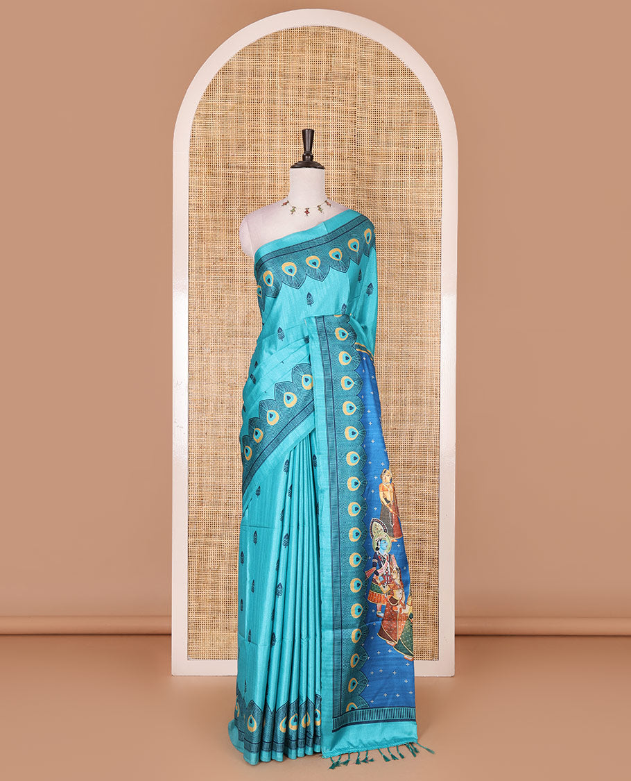 Green peacock feathers motifs printed katan silk saree, peacock feathers printed border, contrast Radha Krishna stories printed pallu, and contrast printed blouse