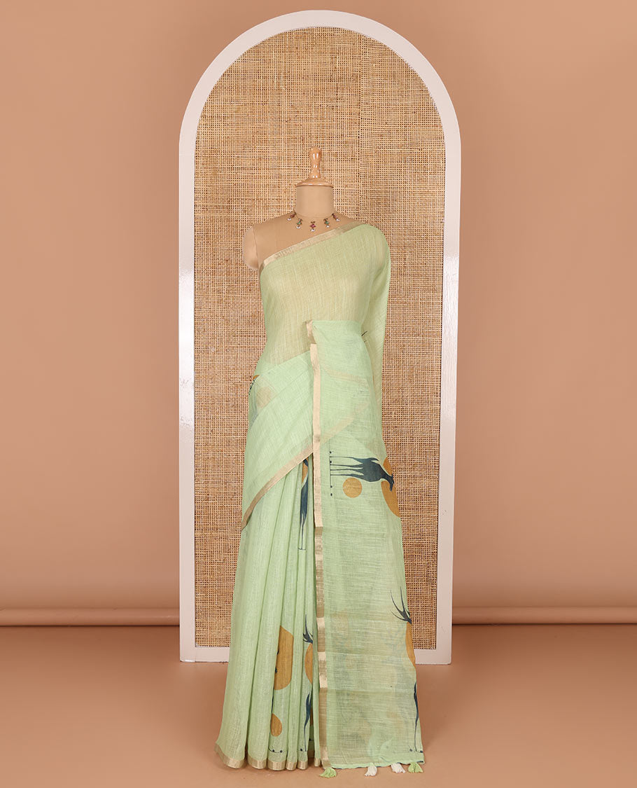 Green sun and deer silhouette printed linen cotton saree, gold zari piping border, printed pallu, and a matching stripes printed blouse