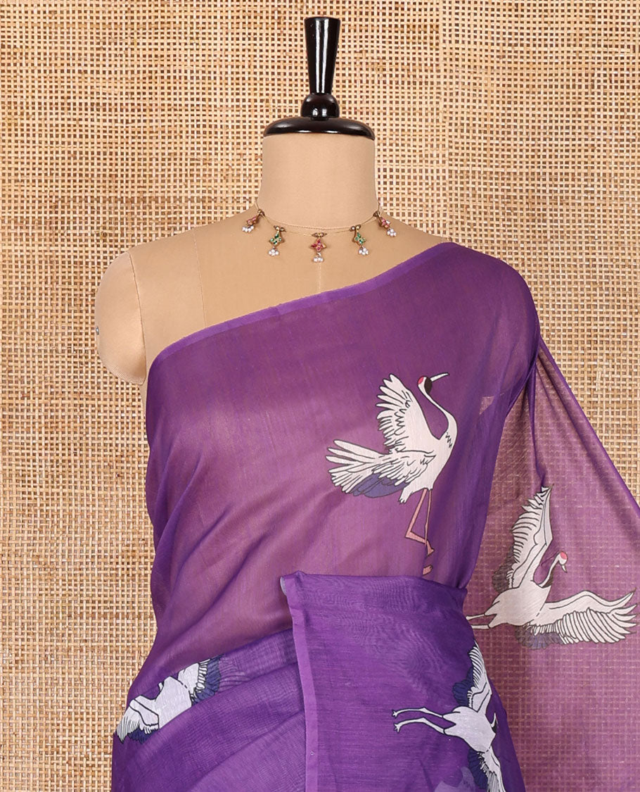 Borderless purple crane motifs printed linen cotton saree, crane motifs printed pallu, and a contrast crane printed blouse