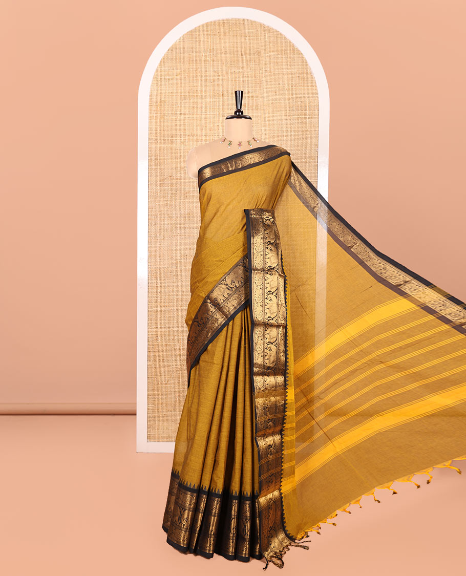 Gold Plain Chettinad Cotton Saree, Complemented by Contrast Temple Traditional Zari Border of Peacock and Elephant Designs, Subtly Striped Pallu, and Paired with a Matching Blouse