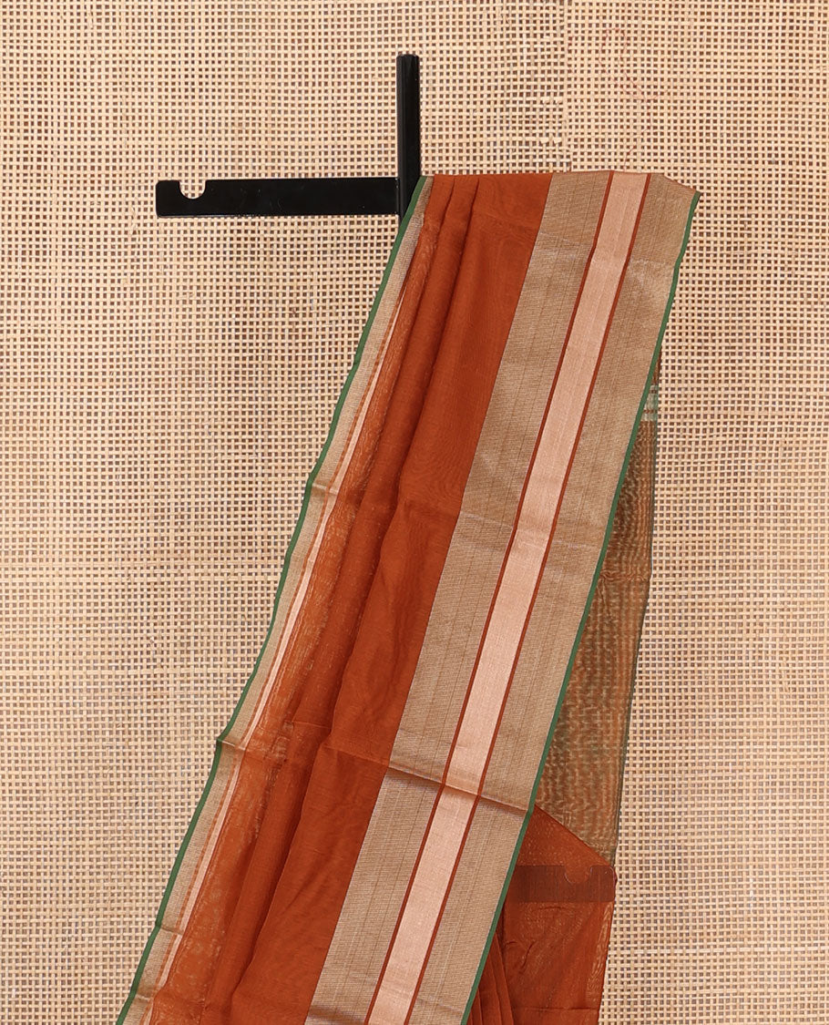 Rust plain silk cotton saree, contrast zari border, and plain pallu