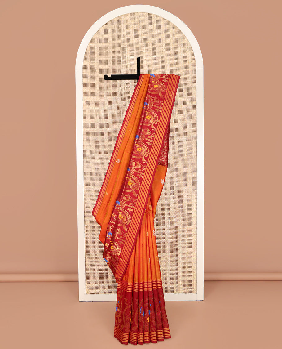 Orange Uppada Silk Saree, Decked Up with Zari Buttas on Its Body, Complemented by a Contrast Border Featuring Floral and Meenakari Bird Designs, Pallu Steeped with Flower Designs, and Paired with a Contrast Blouse