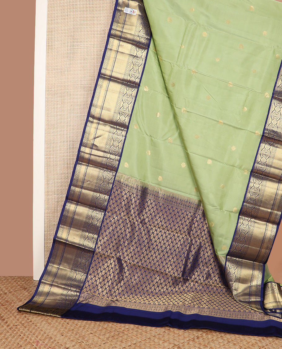 Green zari buttas silk saree, contrast border of rekku, muthu, kamalam, diamond, and mayil kann designs, and jaal pallu