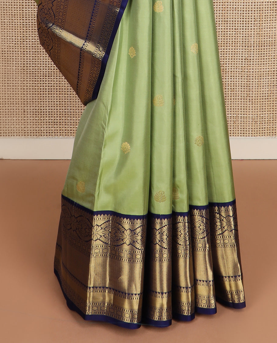 Green zari buttas silk saree, contrast border of rekku, muthu, kamalam, diamond, and mayil kann designs, and jaal pallu