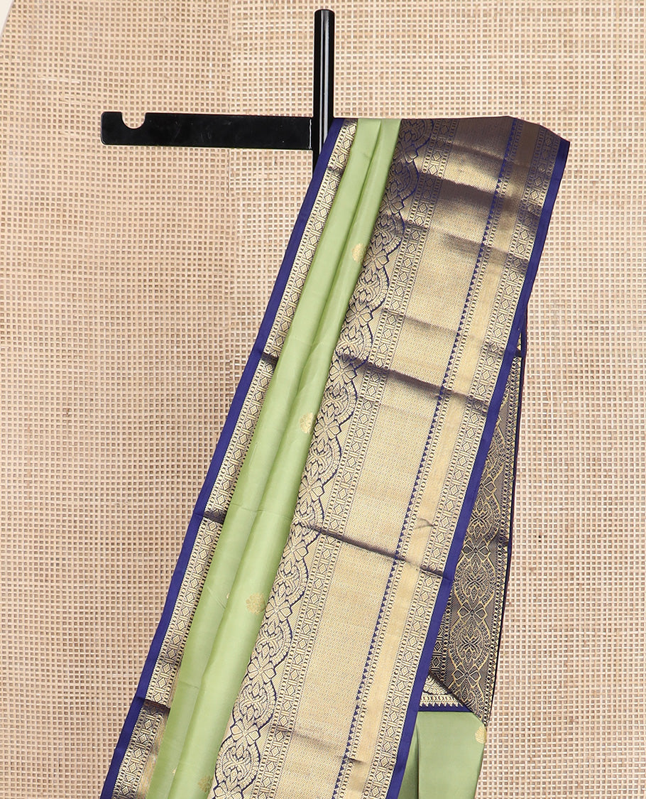 Green zari buttas silk saree, contrast border of rekku, muthu, kamalam, diamond, and mayil kann designs, and jaal pallu