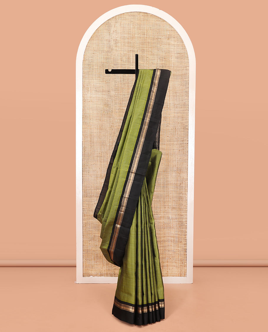 Green Mayuri Lite Silk Mix Saree, Subtly Sparkled with Checks on Its Body, Complemented by a Contrast Kal Eragina Border of Salngai, Muthu, and Then Kuli Nagam Designs, Intricately Designed Pallu, and Paired with a Contrast Blouse
